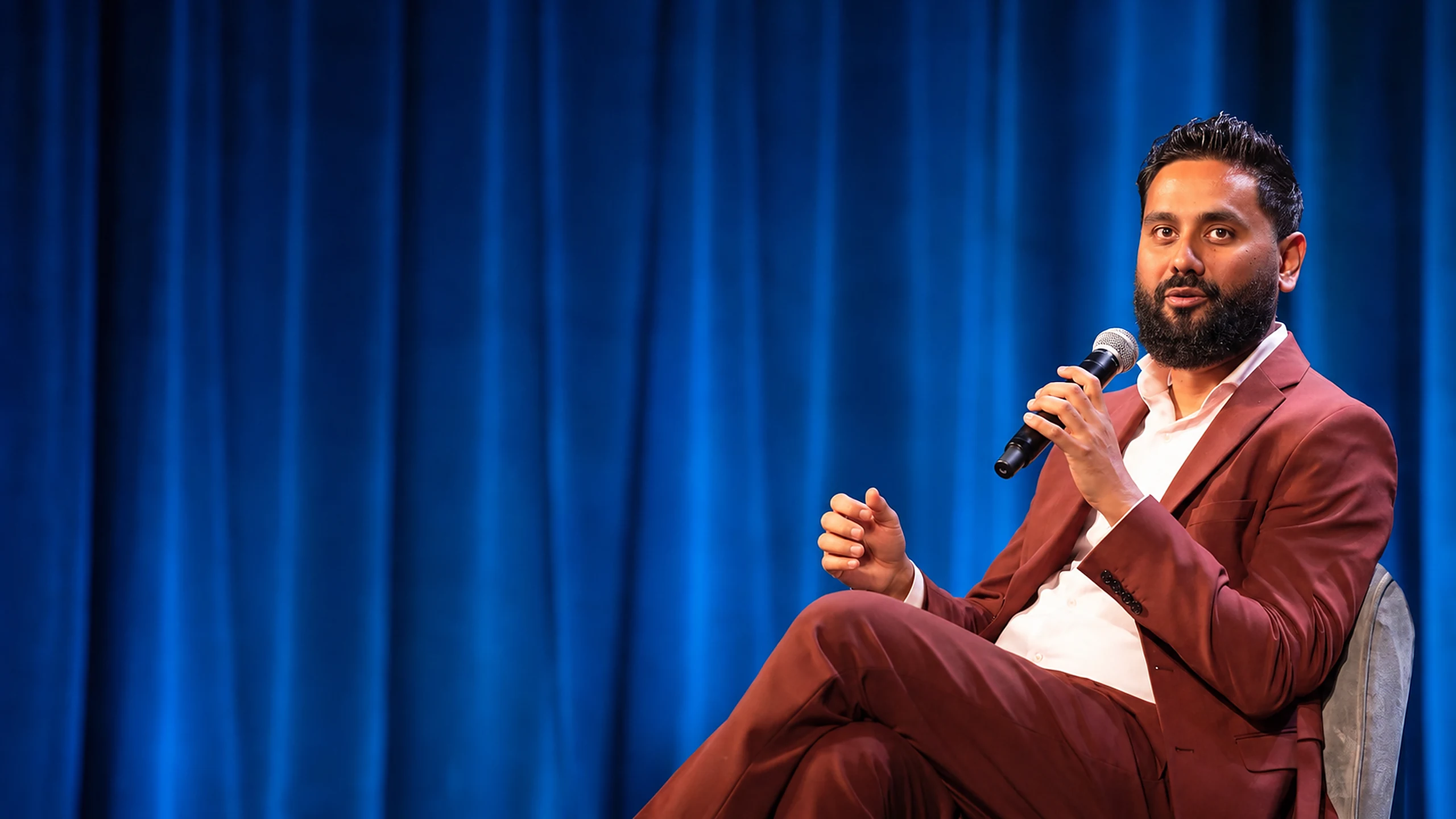 Sabyasachi Sengupta, 2025 World Champion of Public Speaking and Founder of Method-IM, speaking on stage in maroon suit